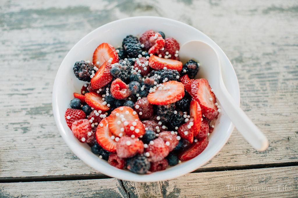 Red, white, and blue fruit salad in a white bowl