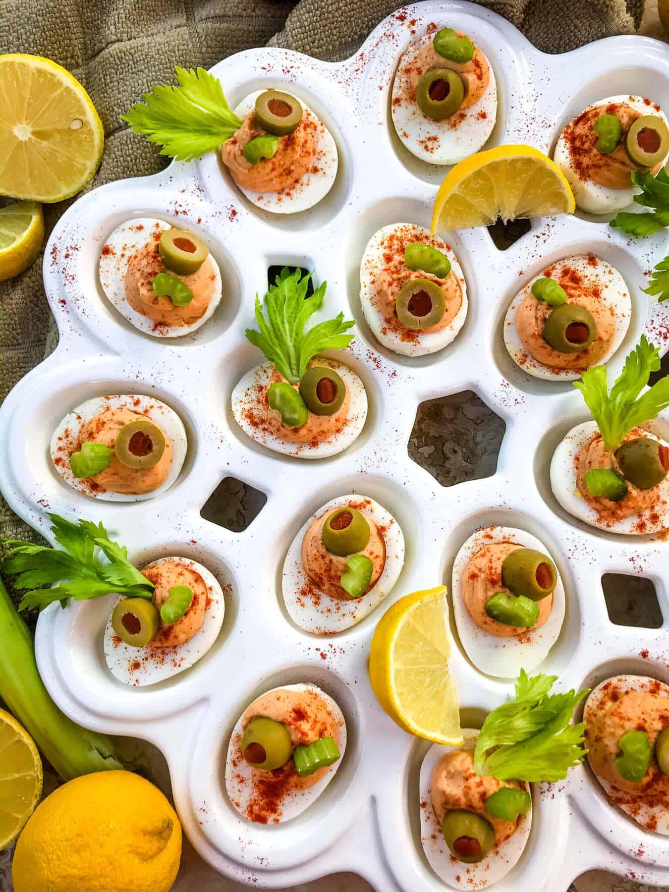 Bloody Mary deviled eggs topped with olives