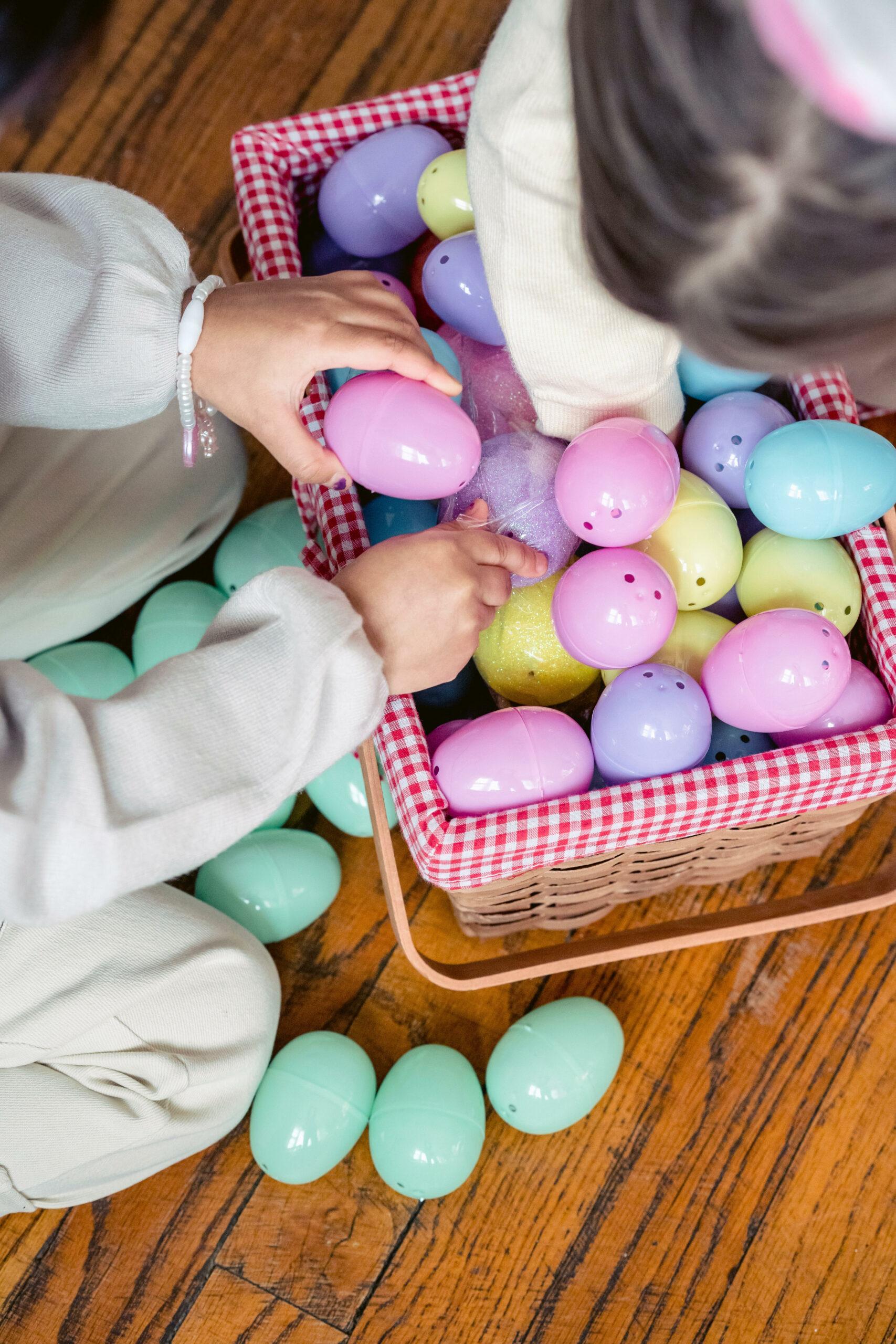 Filling an Easter basket with colorful eggs