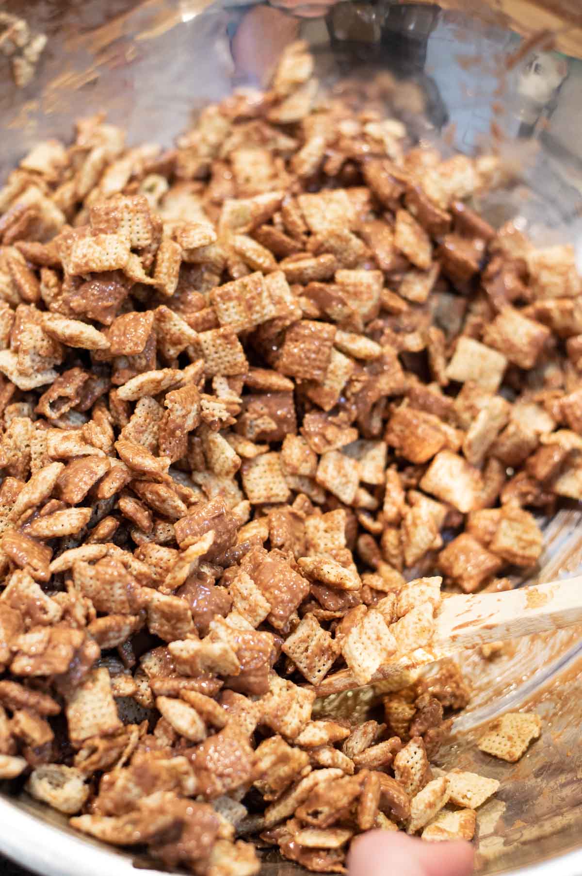 Christmas Reindeer Chex Mix being stirred in a bowl