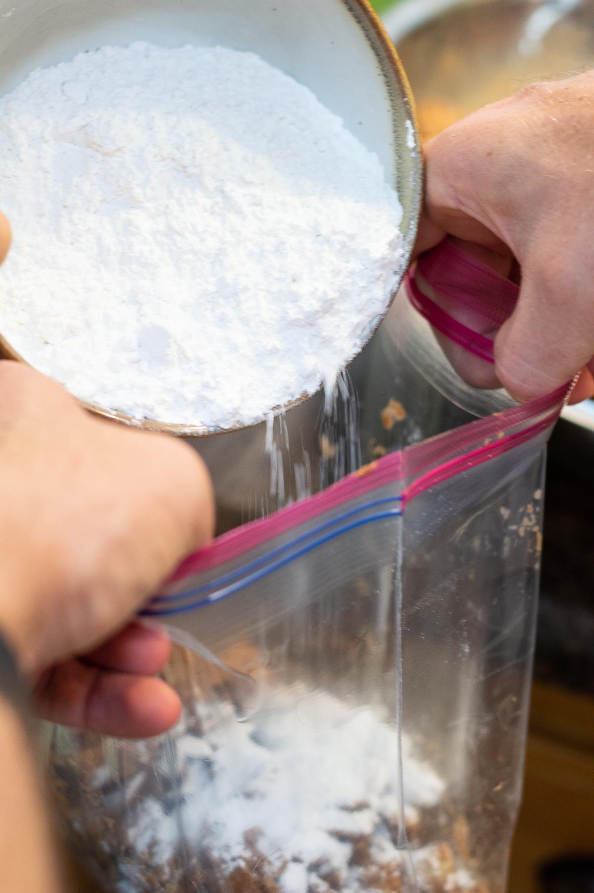 powdered sugar being dumped into a bag