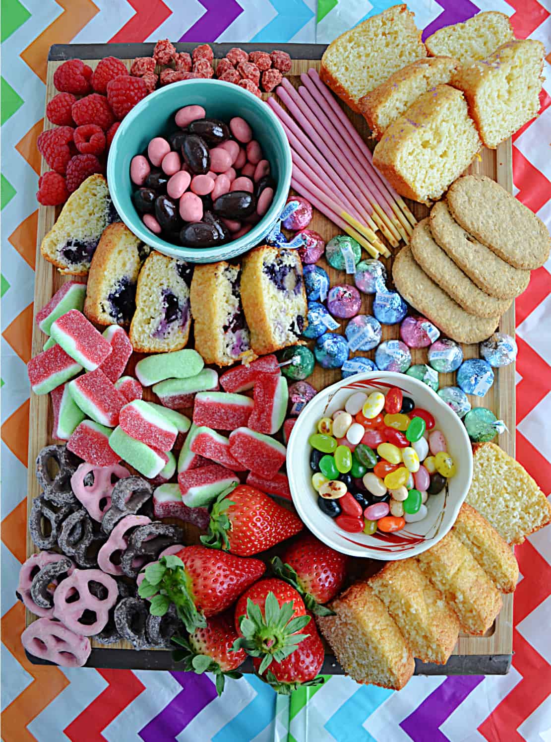 Easter Dessert board with fruits, chocolates, candies, and pound cake.