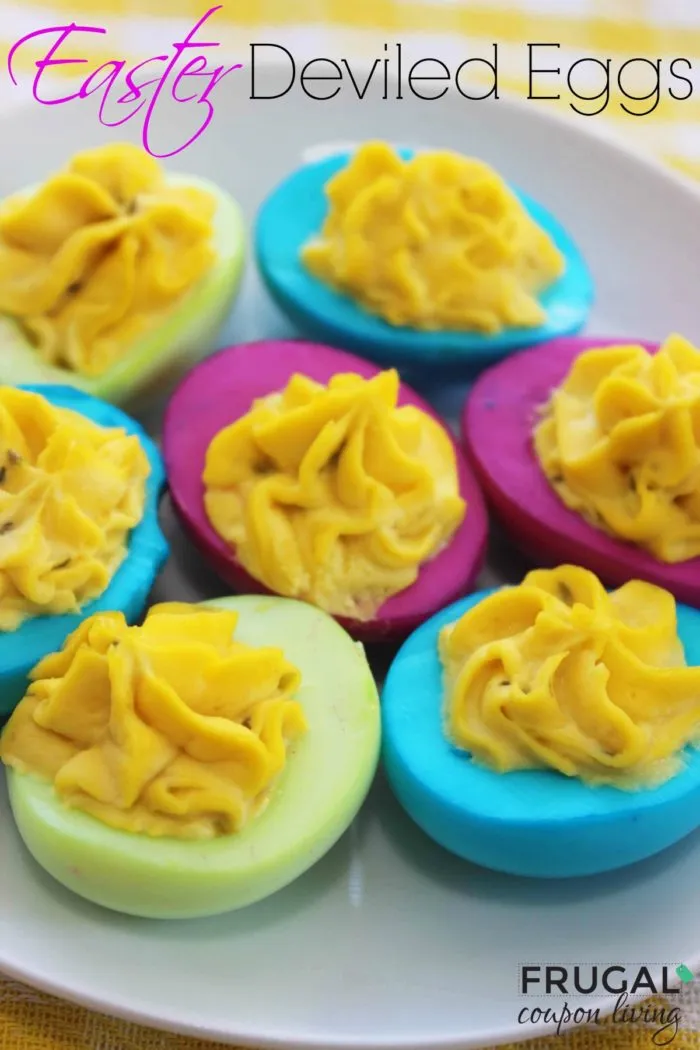 Colorful deviled eggs with yellow filling. The eggs are bright blue, bright pink, and pale green