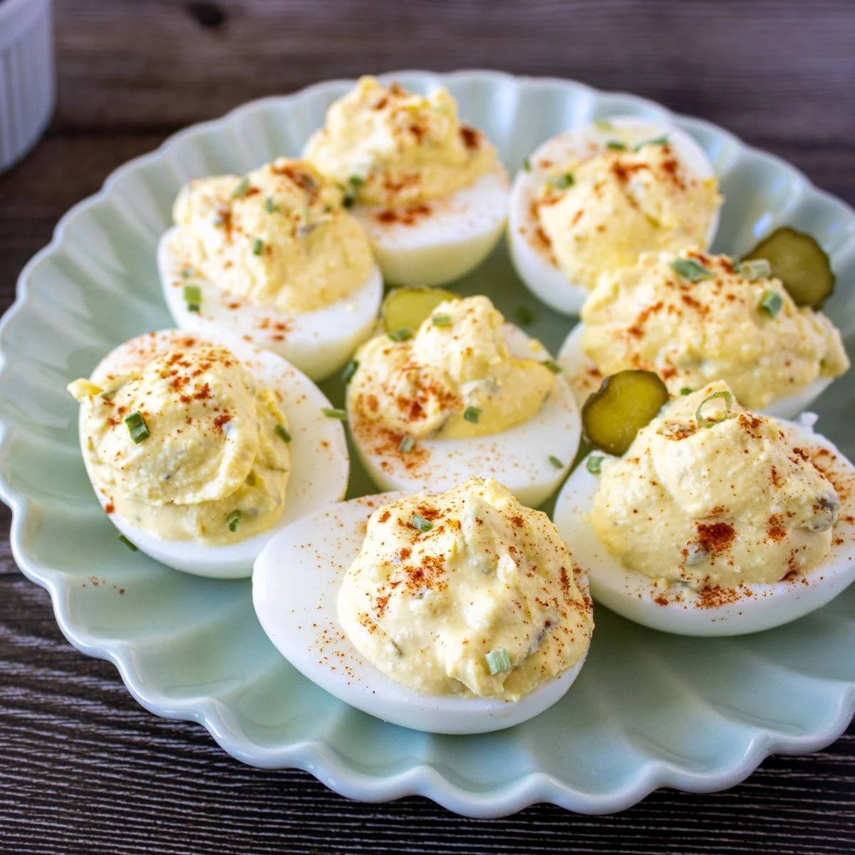 Paula Deen deviled eggs tops with seasoning and pickles