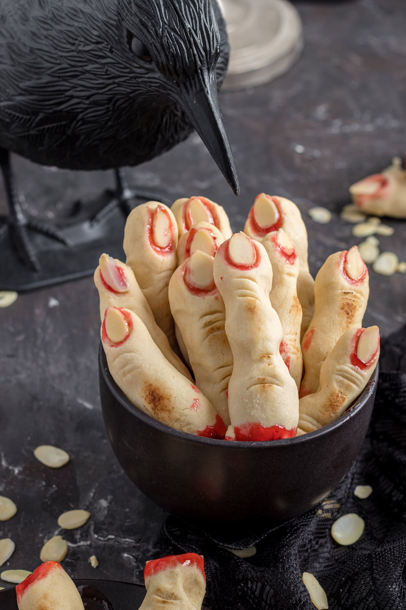 Witch finger cookies with strawberry jam and sliced almonds