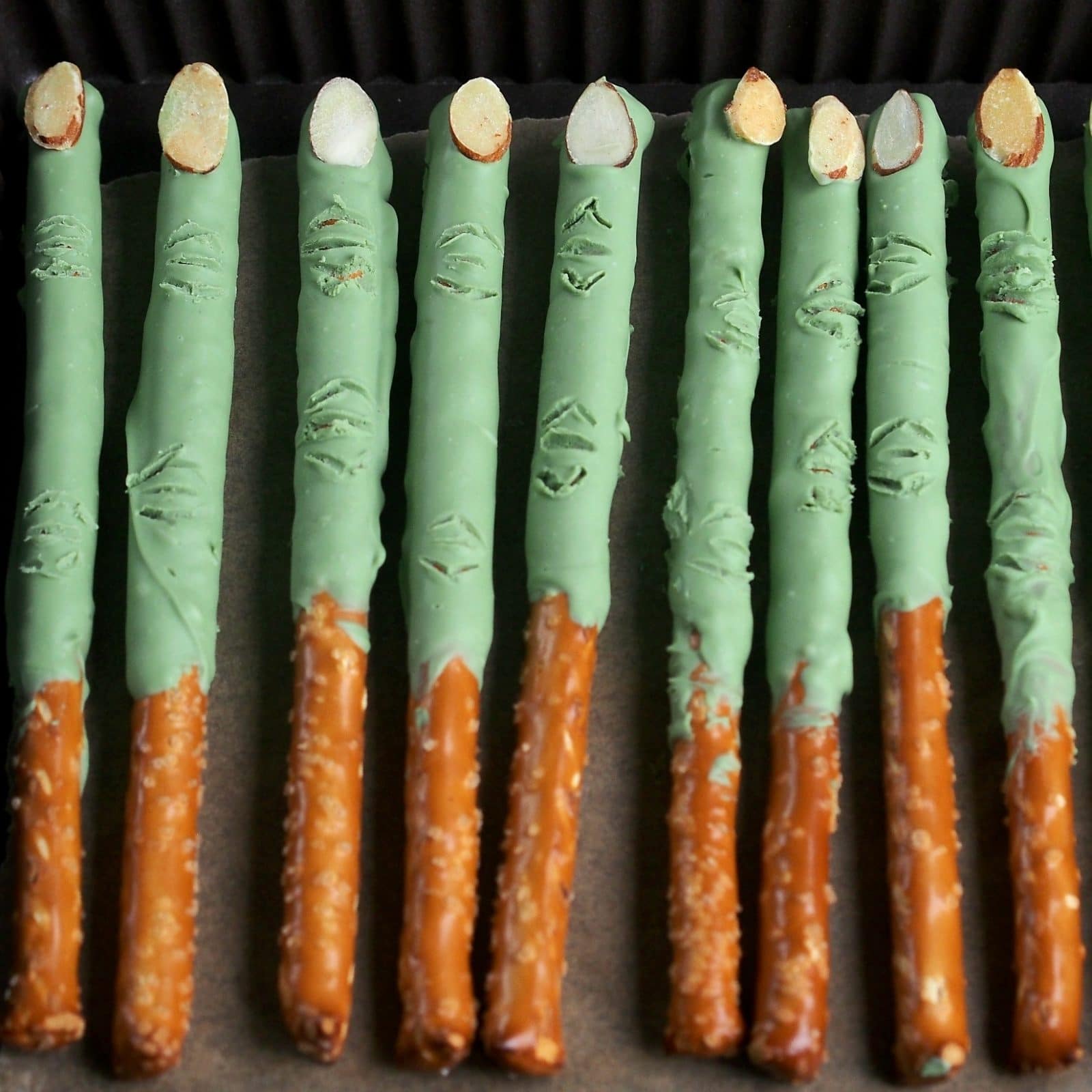 Witch pretzel fingers with green frosting and almonds