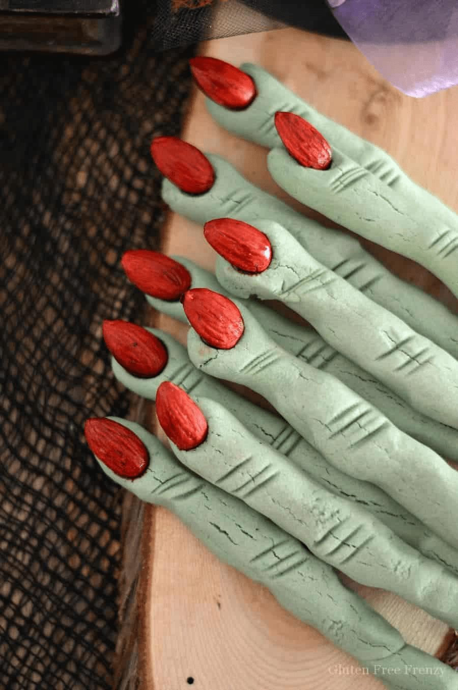 Green witch fingers with red almonds as fingernails
