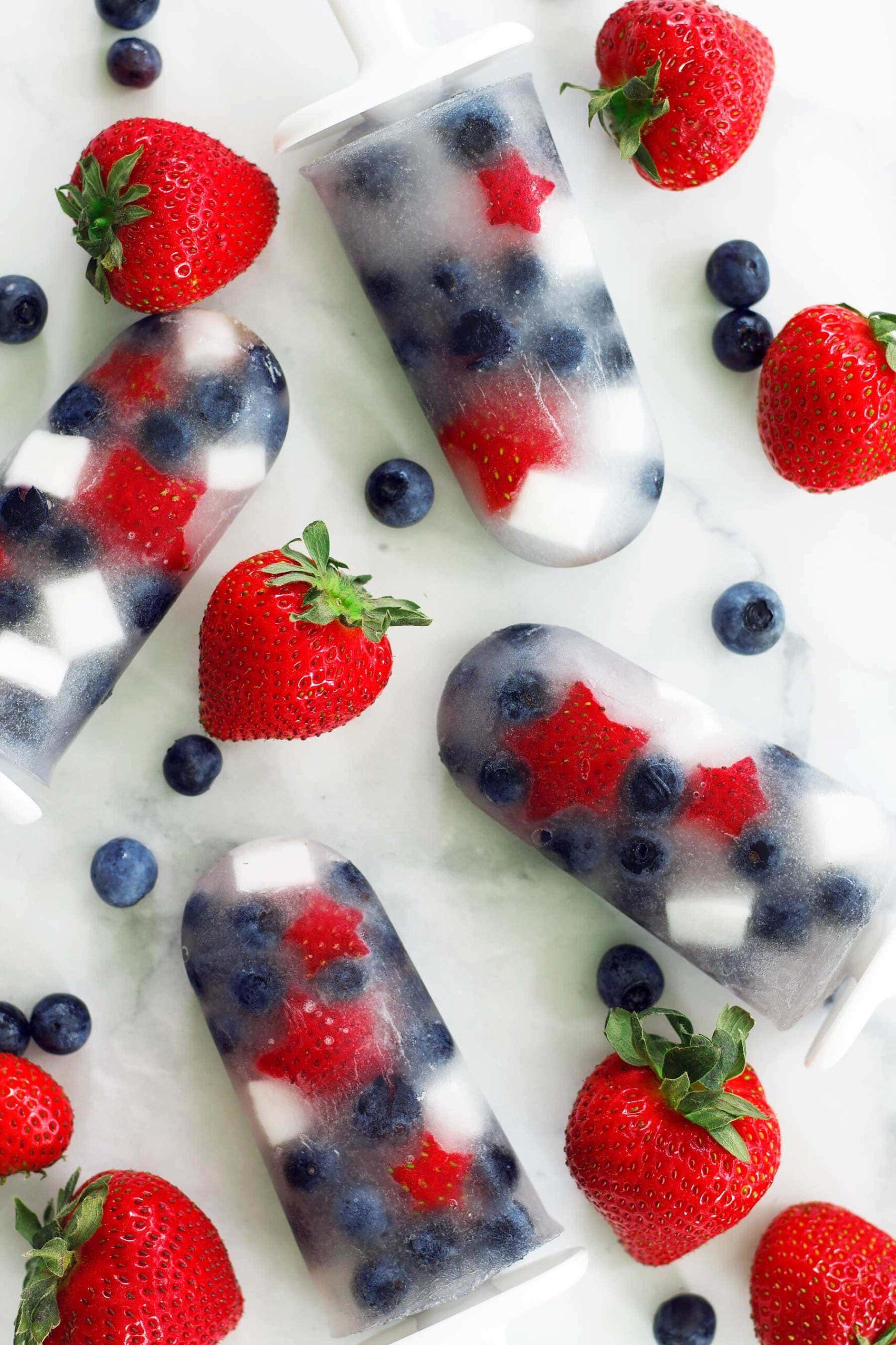 Red, white, and blueberry popsicles with the strawberries shaped like stars
