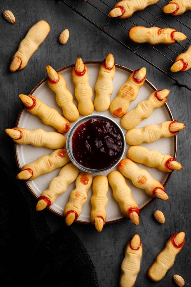 Witch fingers on a plate with jelly in the middle.