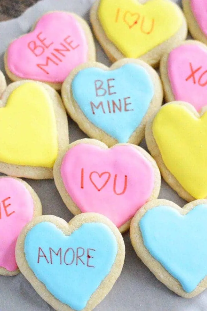 Gluten free conversation heart cookies that say "amore" "I heart you"