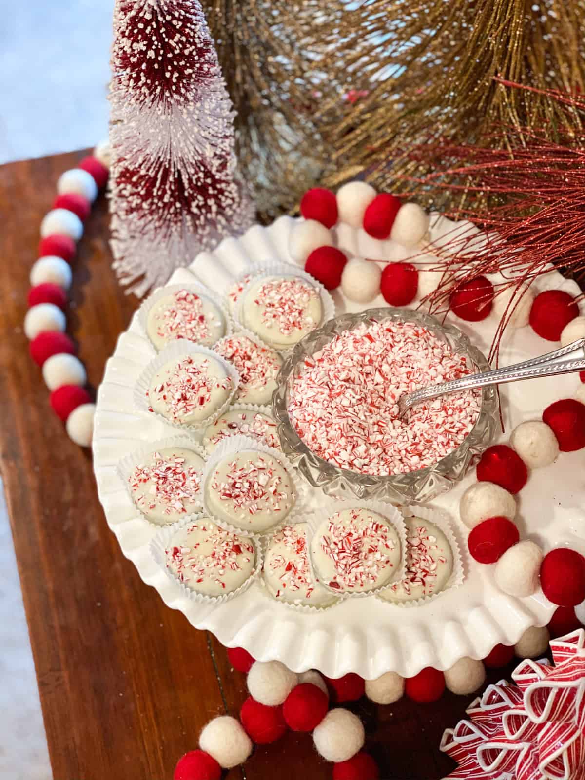Hot cocoa bombs on a tray with peppermint shreds