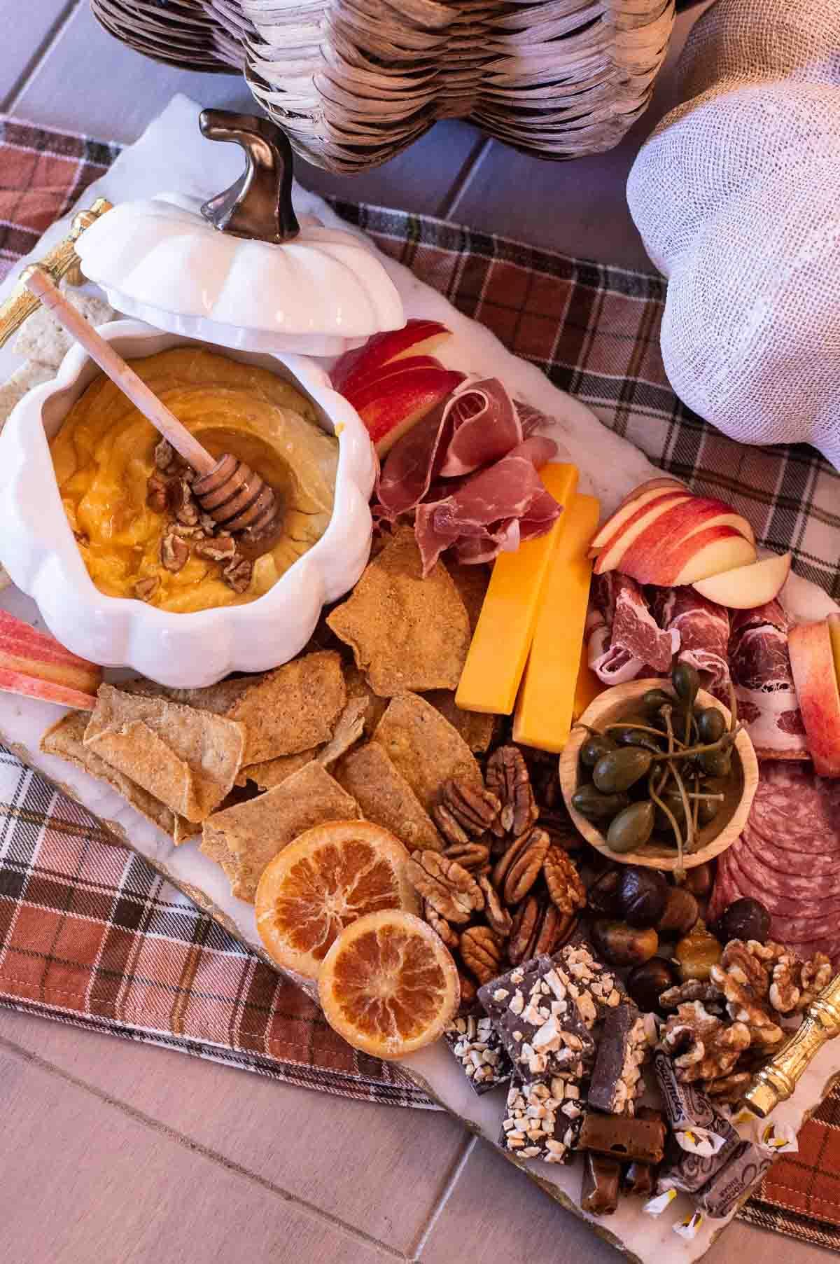 Fall Charcuterie Board with nuts, fruits and pumpkin dip