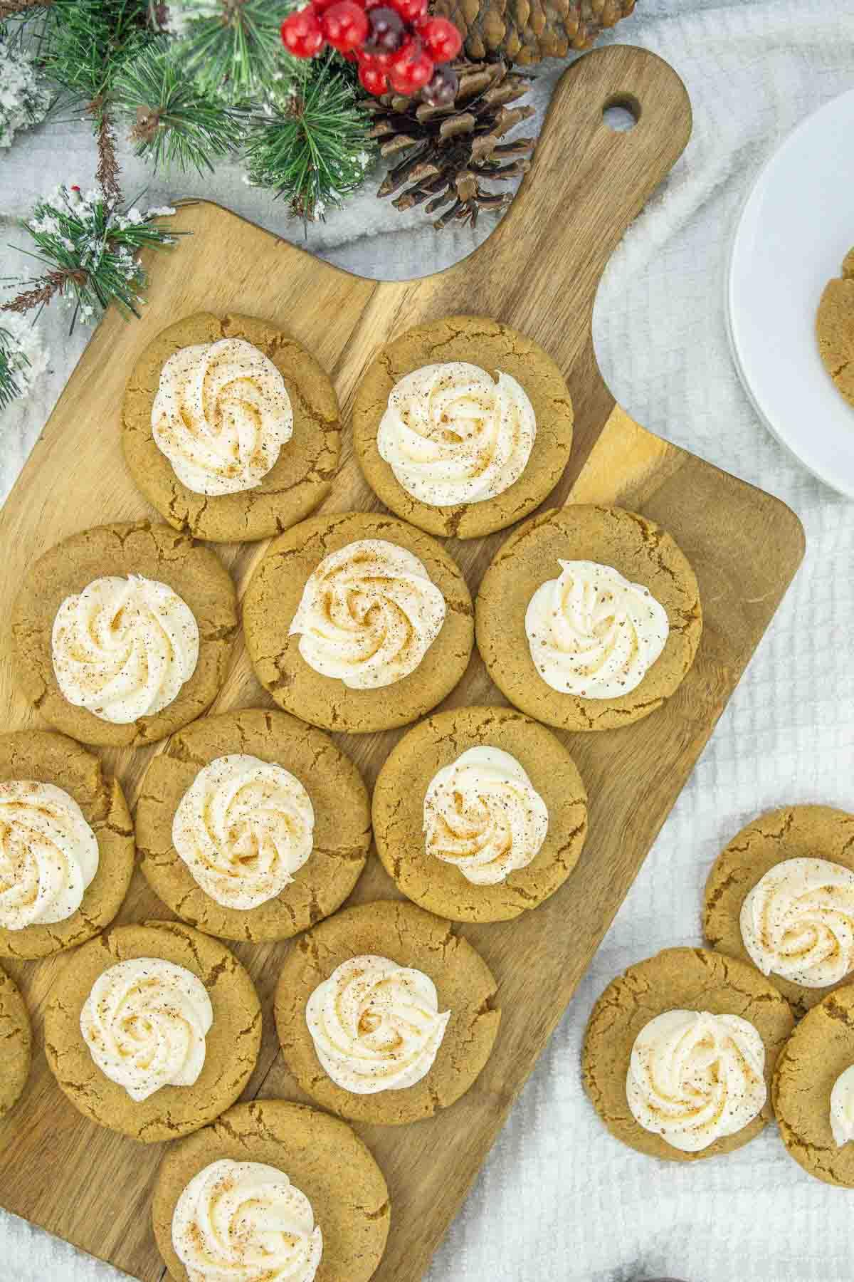 Frosted Ginger Cookies on a wood cutting board