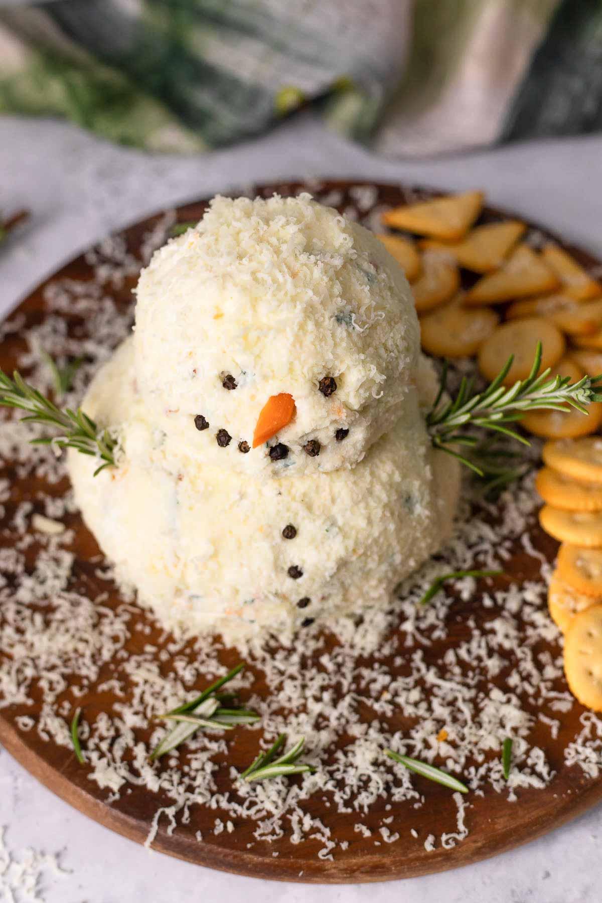 Snowman Cheeseball on a wood tray