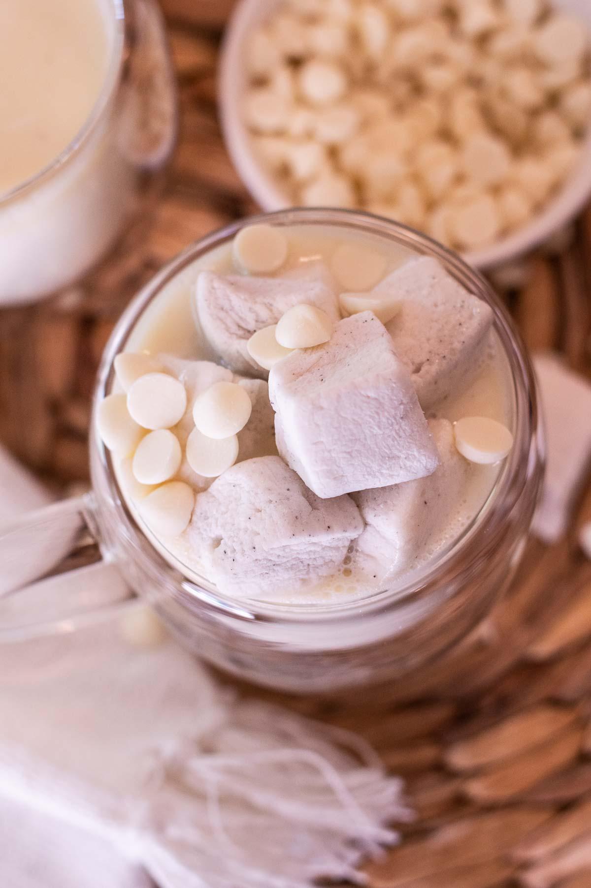 Starbucks White Hot Chocolate in a clear cup with marshmallows and white chocolate chips