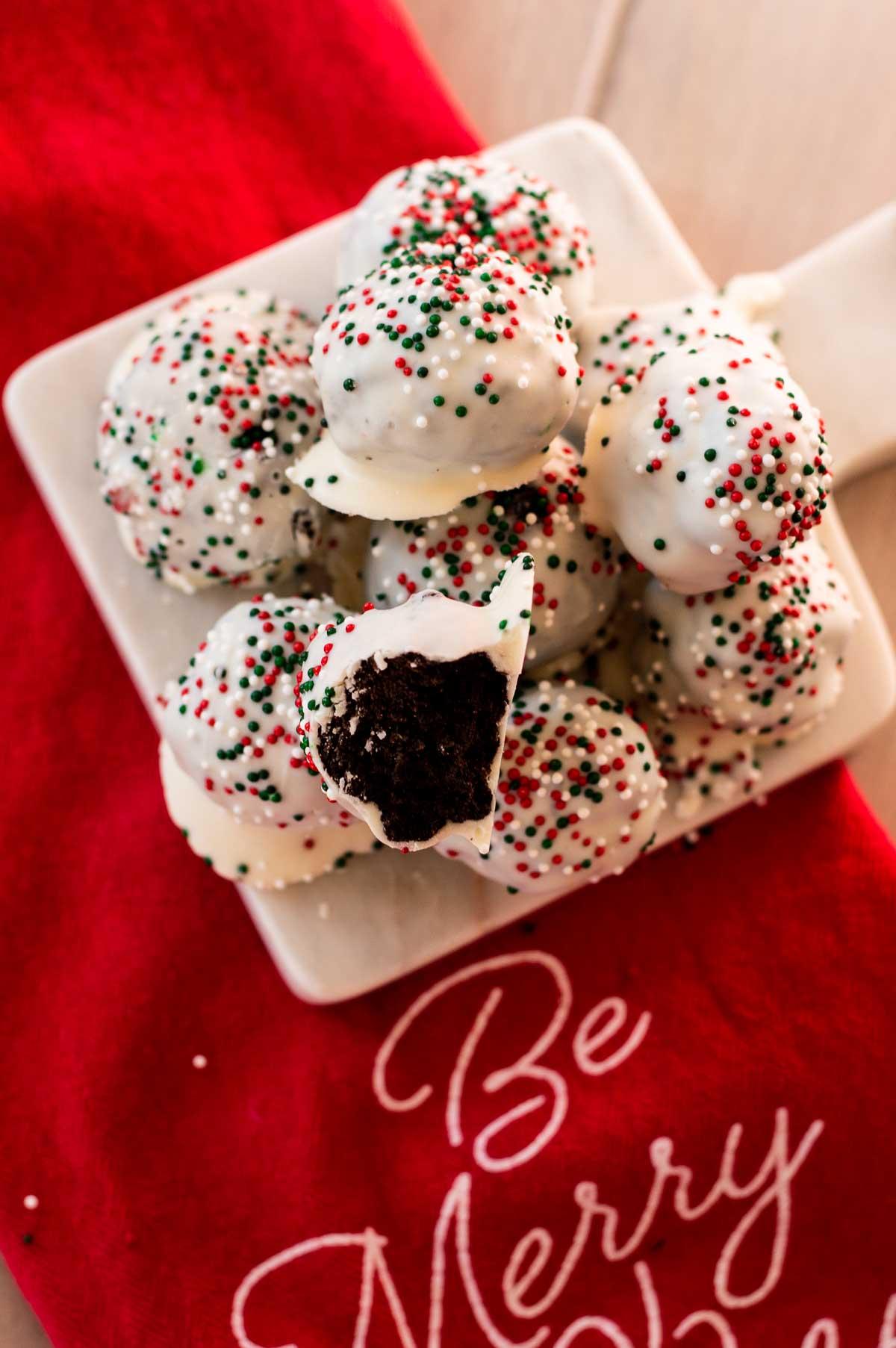 Christmas Oreo Truffles on red towel with bite taken out