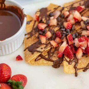 dessert nachos with chocolate sauce and diced strawberries