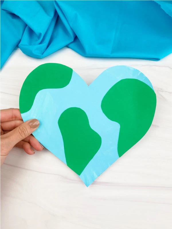 Paper plate cut into the shape of a heart and painted for earth day
