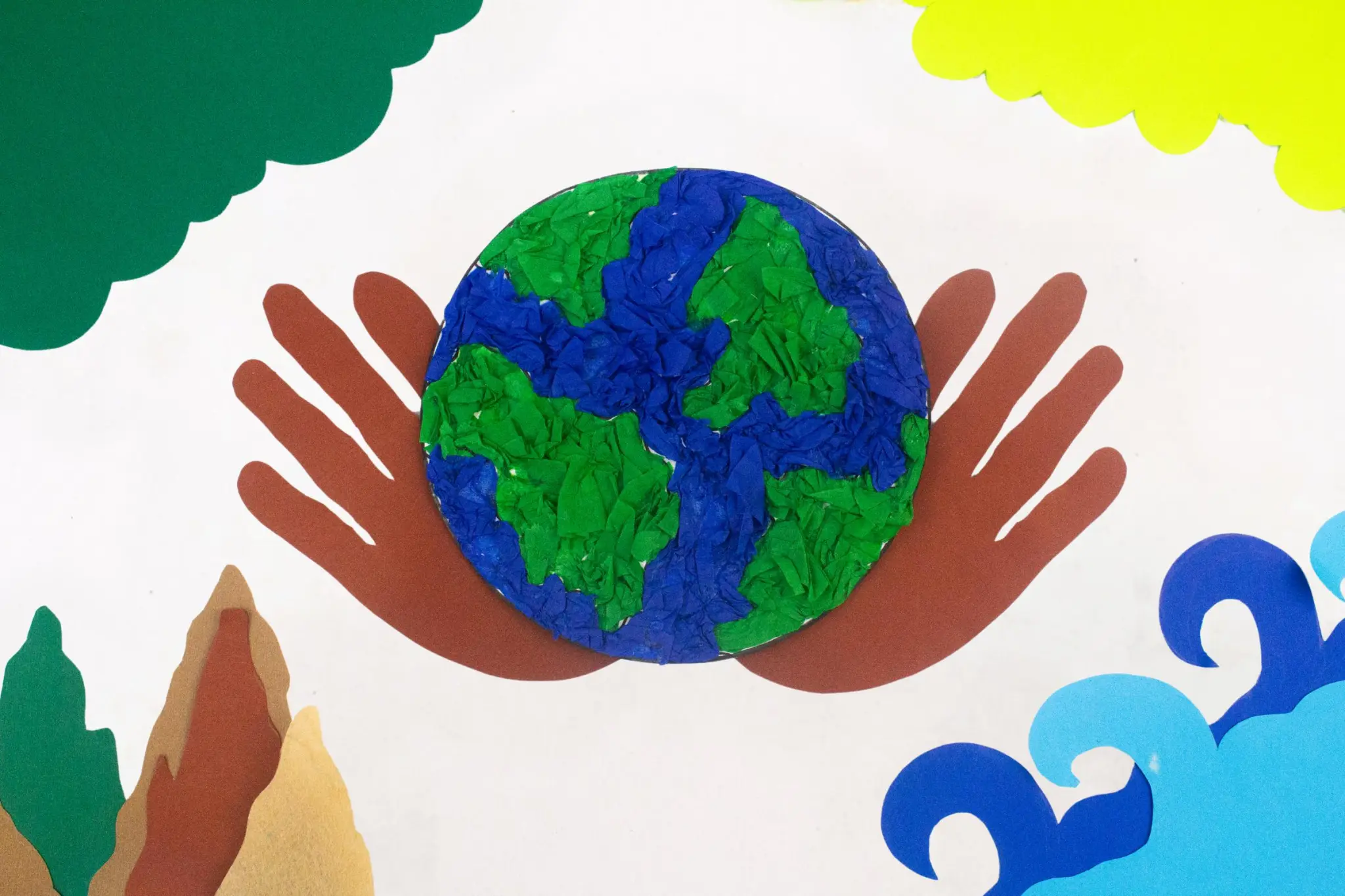 Two hands holding a globe for an earth day craft