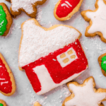 Top down image of a christmas cookie decorate with red and white sugar cookie frosting.
